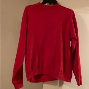 A red, turtle neck sweatshirt